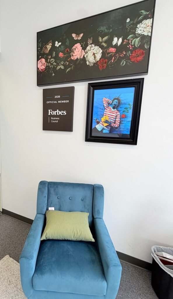 Patient seating area with artwork and a Forbes Business Council 2026 member plaque at Conscientia Health's New Brunswick, NJ office